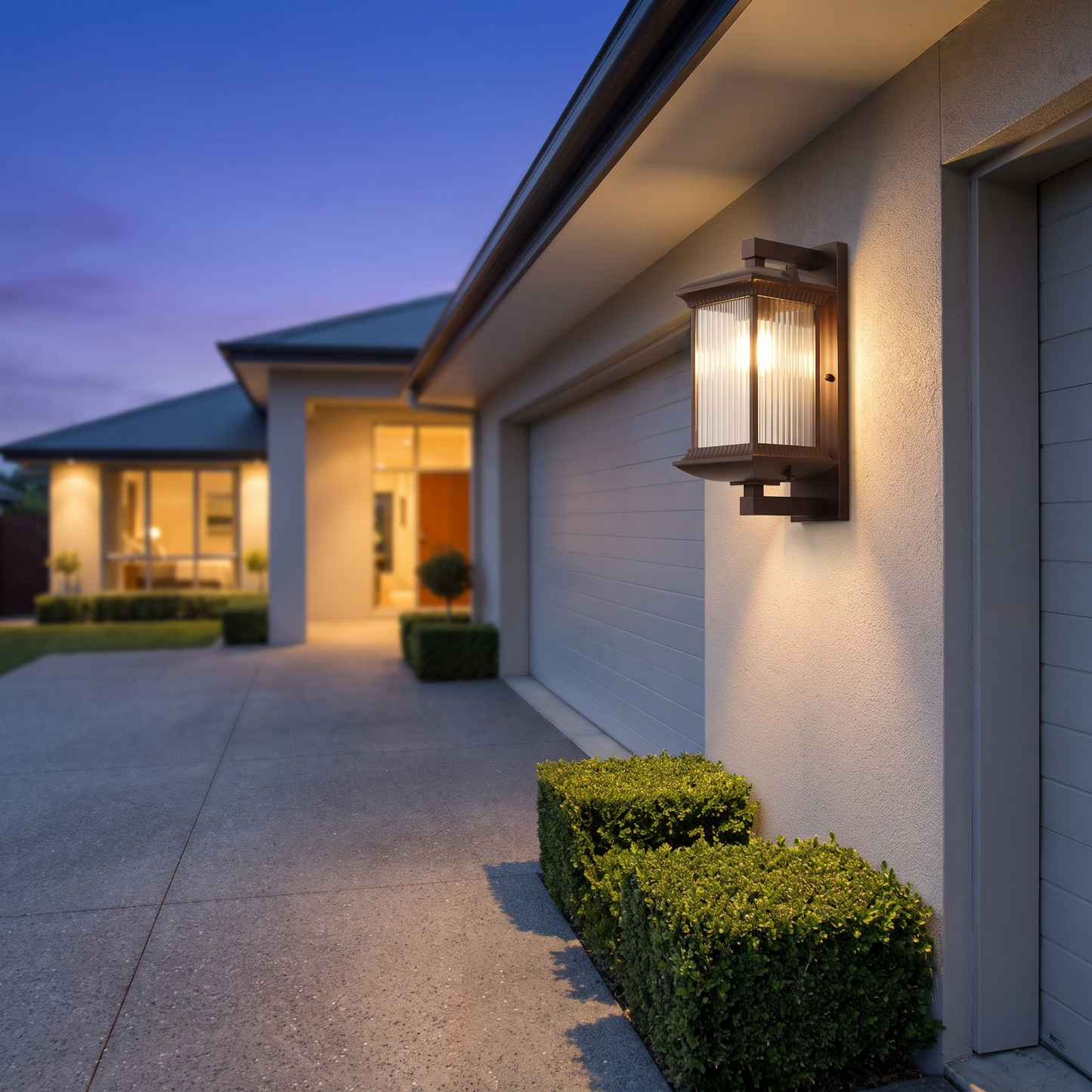 Paragon Dusk-to-Dawn Outdoor Wall Light on a modern home exterior at nightfall